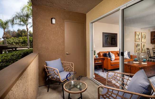 Balcony with two chairs and a table and a sliding glass door at Ascend2300, Carlsbad