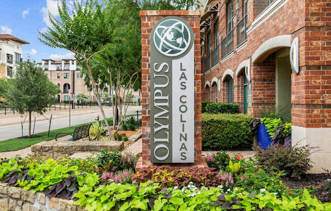 A sign that says Las Colinas in front of a building.