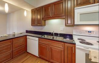 a kitchen with stainless steel appliances and wooden cabinets