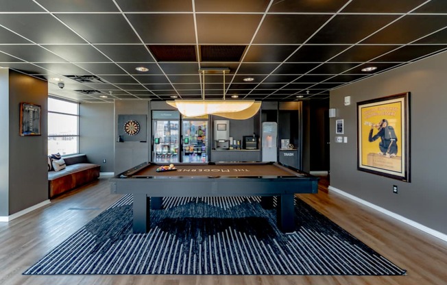 A modern living room with a black and white striped rug.