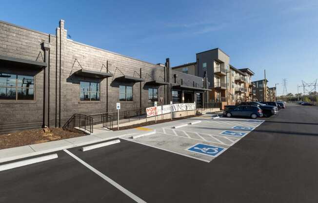 a parking lot in front of a building with cars parked in the parking lot