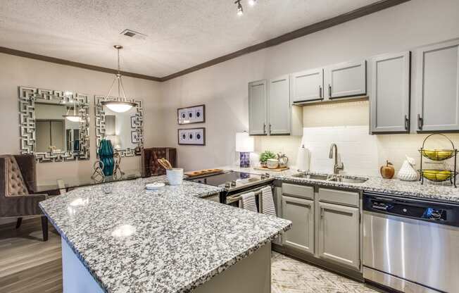 an updated kitchen with granite counter tops and stainless steel appliances