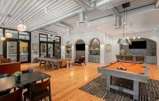 a game room with a pool table and a television