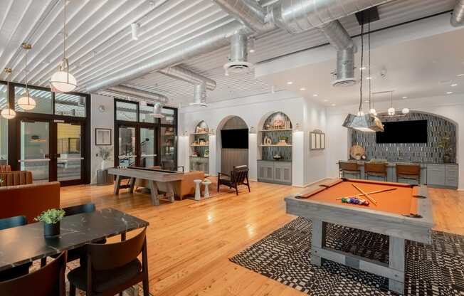 a game room with a pool table and a television