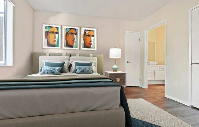 a bedroom with a bed and paintings on the wall