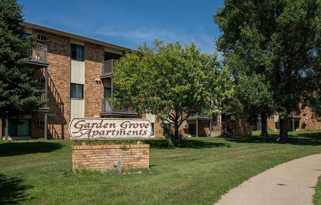 A brick building with a sign that says Garden Grove Apartments. Bismarck, ND Garden Grove Apartments