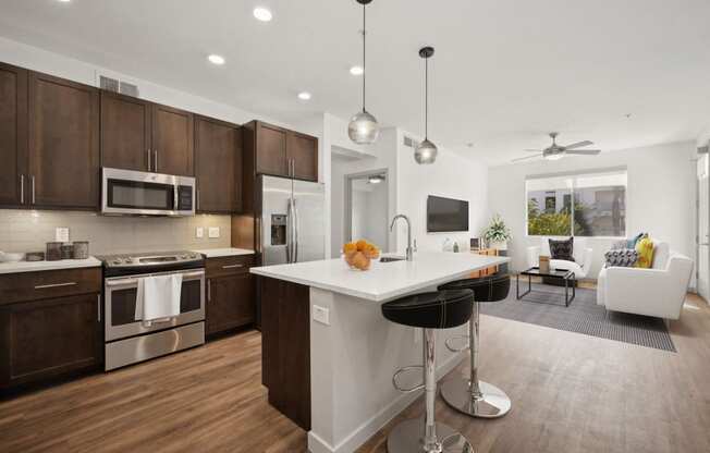 a kitchen and living room with a large white counter top