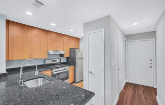 a kitchen with a granite counter top and a sink