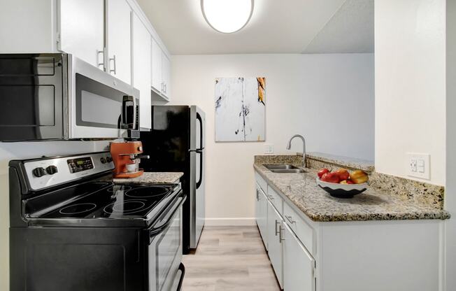 a kitchen with stainless steel appliances and granite counter tops