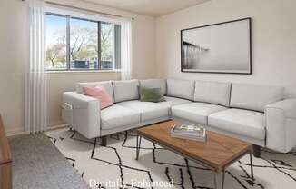 A garden style living room with a grey couch, a wooden coffee table, and a large window with curtains at Walnut Trail Apartments, Portage, MI, 49002