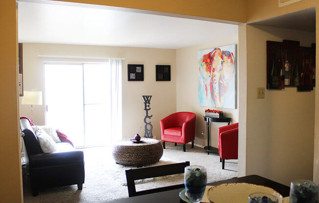 a living room with a couch chairs and a table