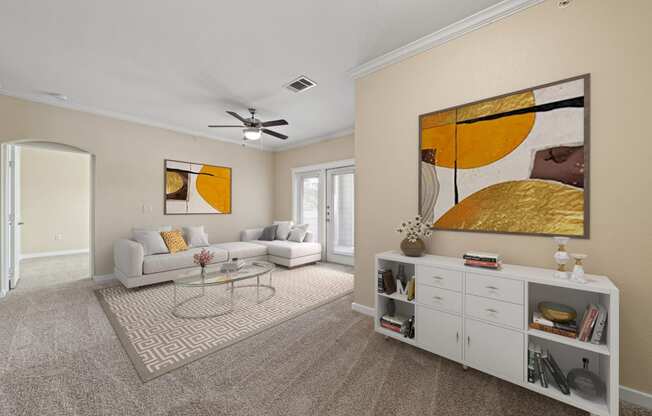 a living room with white furniture and a ceiling fan