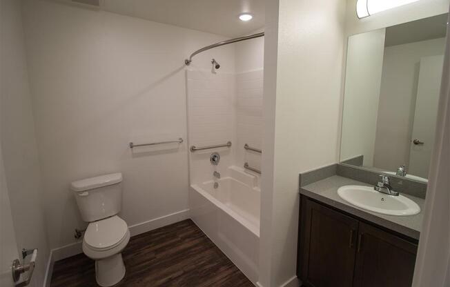 a bathroom with a toilet sink and bathtub at Loma Villas Apartments, California, 92408