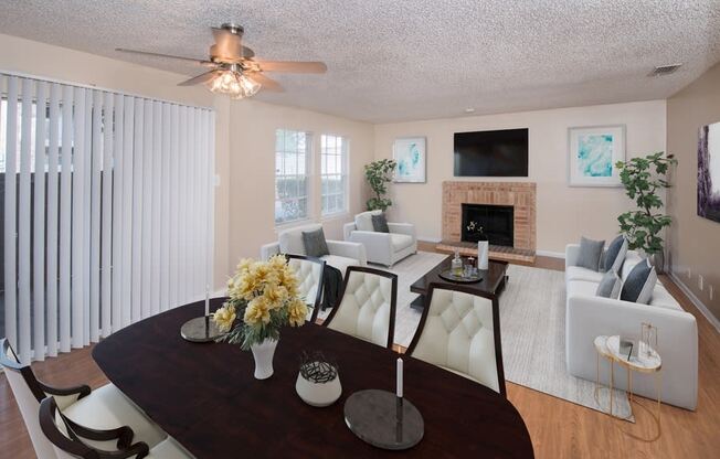 a living room and dining room with a table and chairs