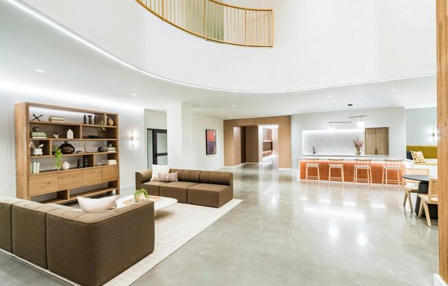 An inviting lounge with open seating, warm finishes, and a bar designed for gathering.