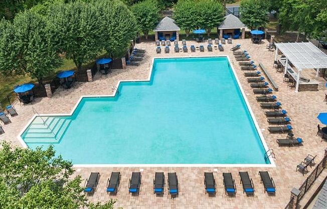 an aerial view of a swimming pool with lounge chairs and umbrellas at Trails at Short Pump Apartments, Richmond ,23233