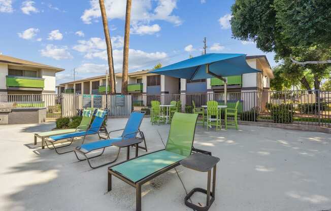 our apartments have a patio with chairs and umbrellas