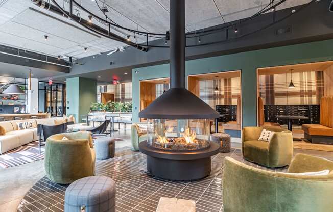 the lobby of a hotel with a large fire pit