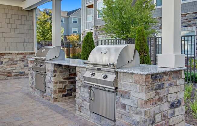 Outdoor grilling. Grill, countertops, seating and seating. at York Woods at Lake Murray Apartment Homes, Columbia