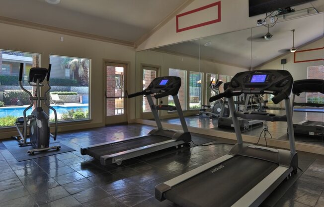 treadmill in front of mirror of fitness room
