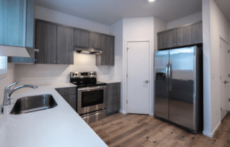kitchen with a refrigerator, stove, and sink