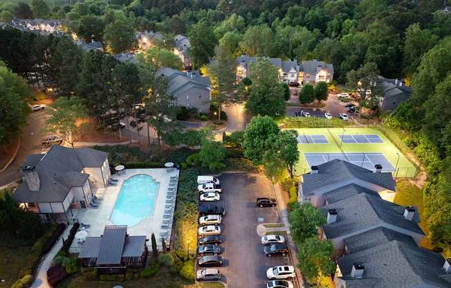 A residential area with houses, a swimming pool, and tennis courts.