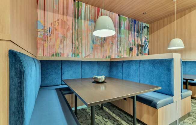 a dining room with blue chairs and a wooden table