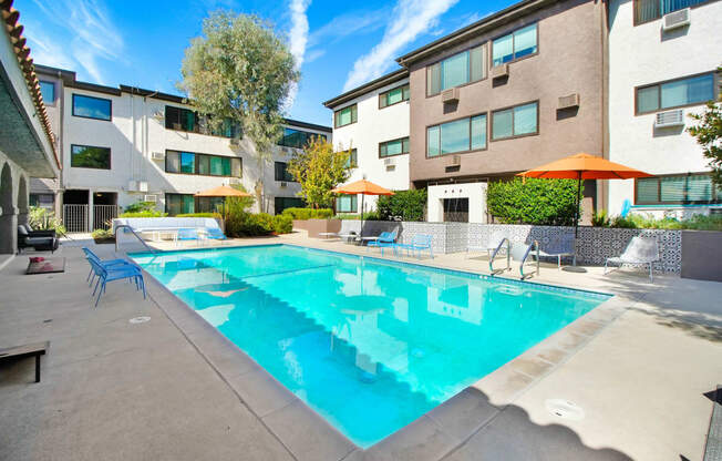 our apartments have a pool and lounge areas with umbrellas