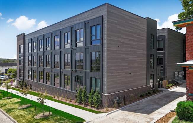 a large building with a sidewalk in front of it