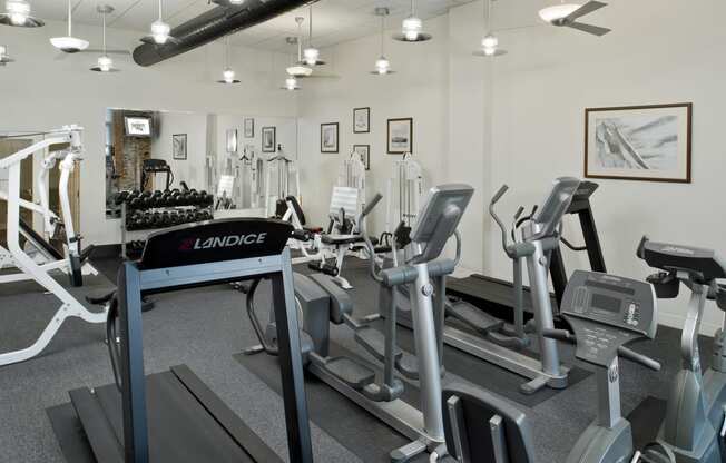 a gym with treadmills and other exercise equipment at Tindeco Wharf, Baltimore, MD 21224