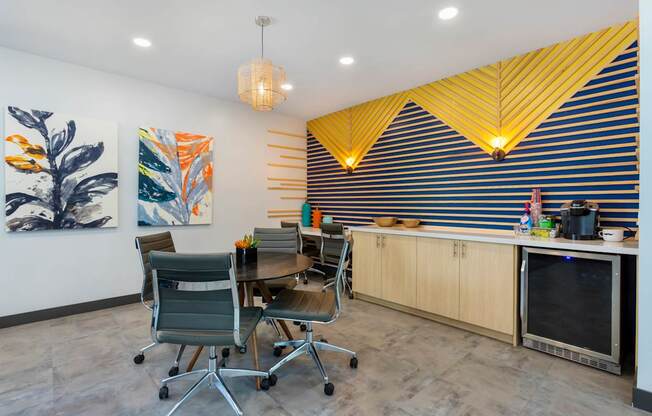 A modern kitchen with a dining table and chairs.