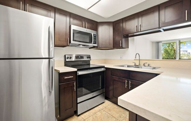 Apartments for Rent in Culver City, CA - Parkway Plaza Kitchen with stainless steel appliances, and modern dark wood cabinets