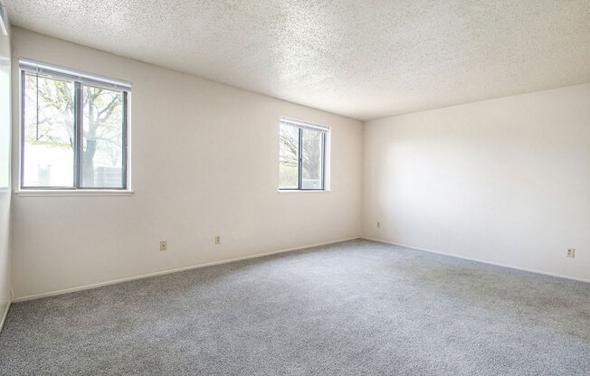 studio living room with two windows at Old Farm Apartments, Elkhart, Indiana