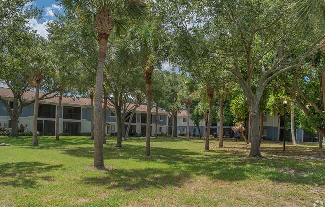 a building with trees and grass in front of it