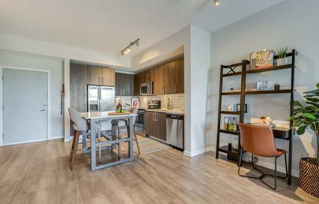 a kitchen and dining area with a bar and a refrigerator