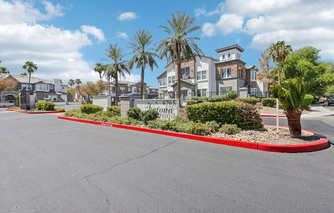 an empty street with palm trees in front of houses