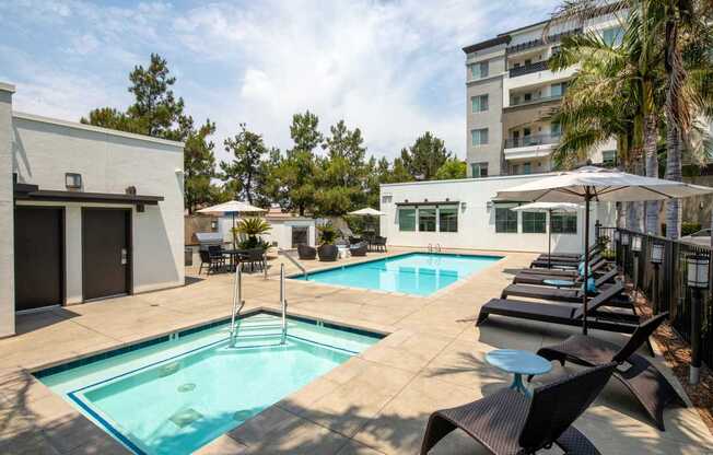 A pool with a ladder and a table with chairs.