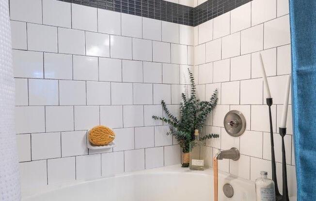 a white bath tub sitting next to a shower