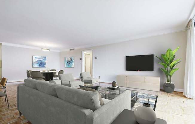 A living room with a grey couch and a black television.