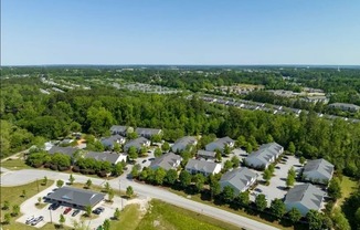 A bird's eye view of a residential area with houses and a community center.