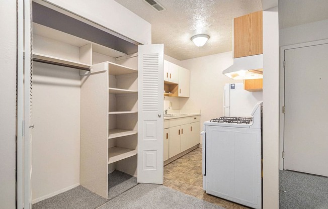 a kitchen with white appliances and a closet at Granada Apartments, Jackson
