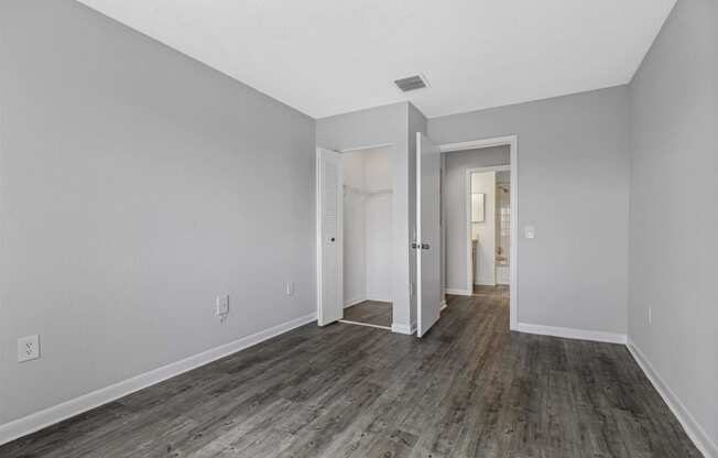 a renovated living room with wood floors and white walls