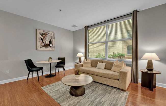 A living room with a couch, chairs, and a coffee table.