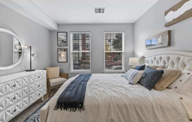 a bedroom with a large bed and two windows  at Harbor Pointe, New Jersey, 07002