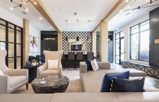 a living room with a couch and chairs and a table