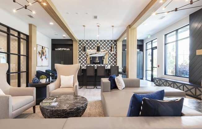 a living room with a couch and chairs and a table