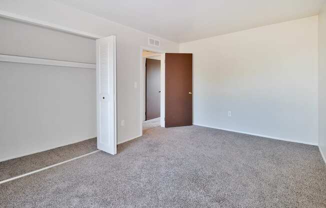 Comfortable bedroom with ample closet space at Farmbrooke Manor Apartments Clinton Township MI