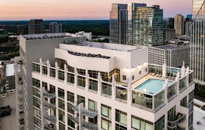 an aerial view of a skyscraper with a pool on the roof of a building