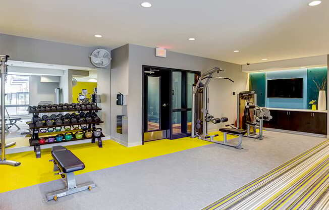 a gym with weights and other equipment in a building