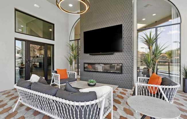 A modern living room with a fireplace and a television.